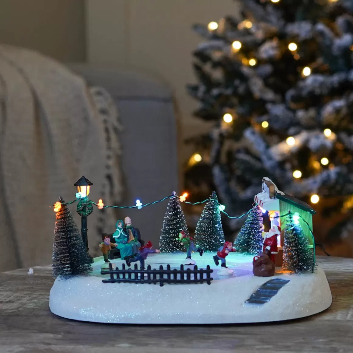 It's all about Christmas Christmas Houses In All Shapes And Sizes-Christmas Village Ice Rink | 4 Moving Skaters | LED Lighting | Music | 29cm Wide