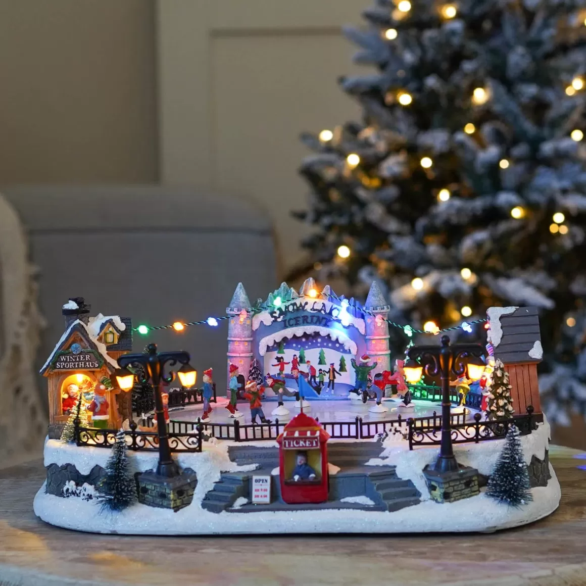 It's all about Christmas Christmas Houses In All Shapes And Sizes-Christmas Village Ice Rink | 8 Moving Skaters | LED Lighting | Music | 42cm Wide